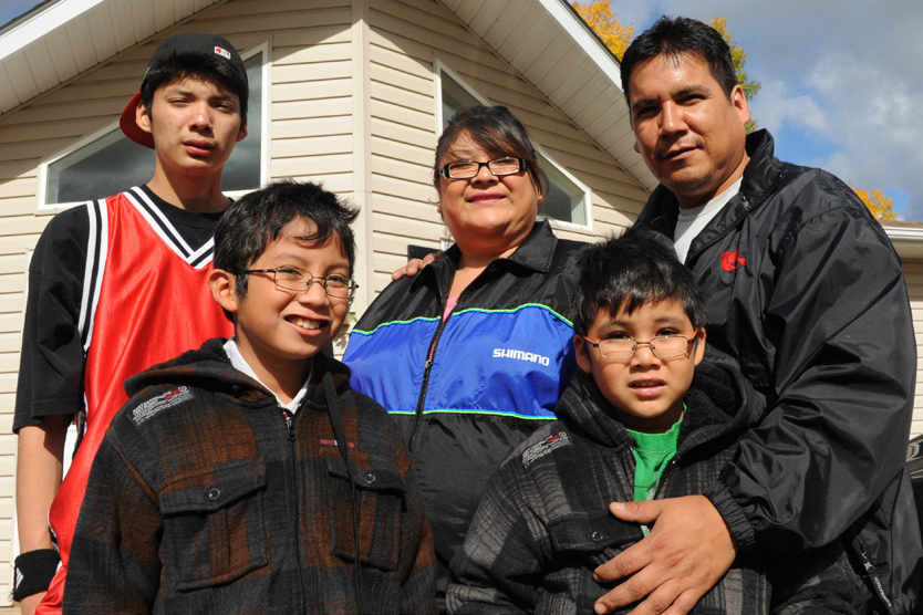 family standing in front of house