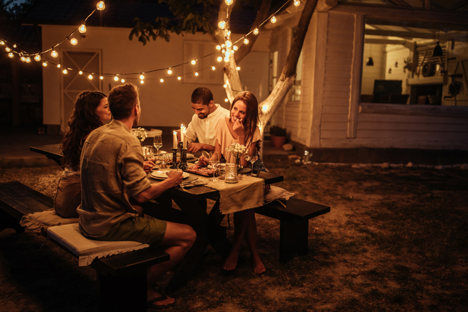 Friends enjoying dinner together outside